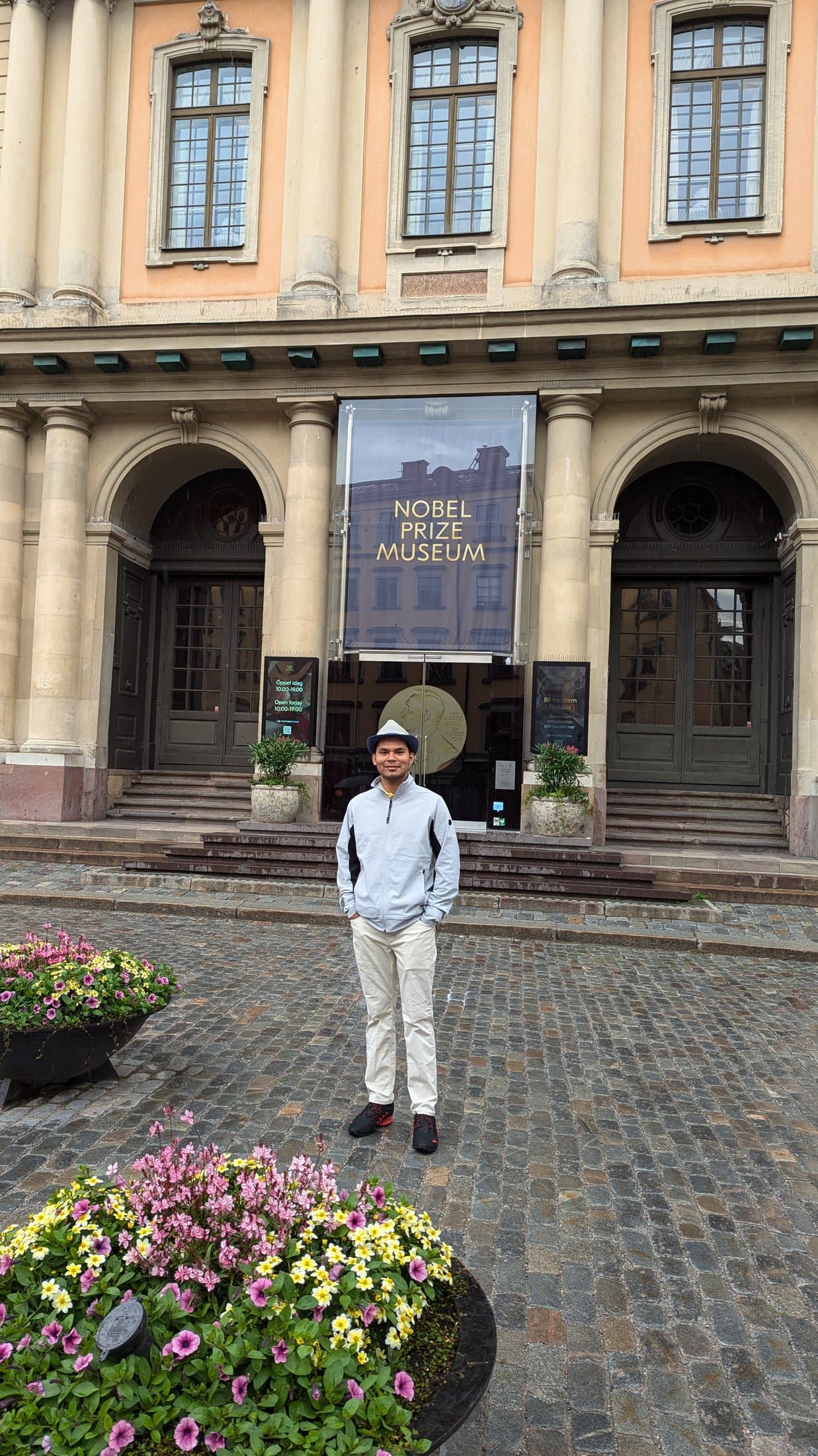 Shivam standing in front of the entrance to the Nobel Prize Museum in Stockholm, with the museum's signage visible above the doorway.